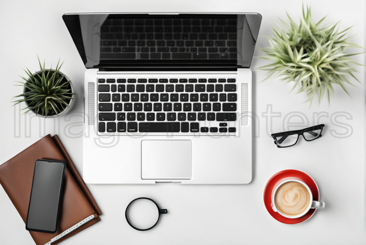 Top view of office desk with laptop, smartphone, coffee cup, glasses, and plants on white table.