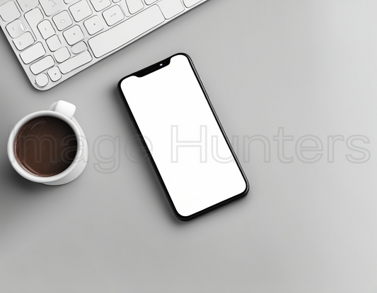 Smartphone mockup, coffee, and keyboard arranged on desk viewed from above